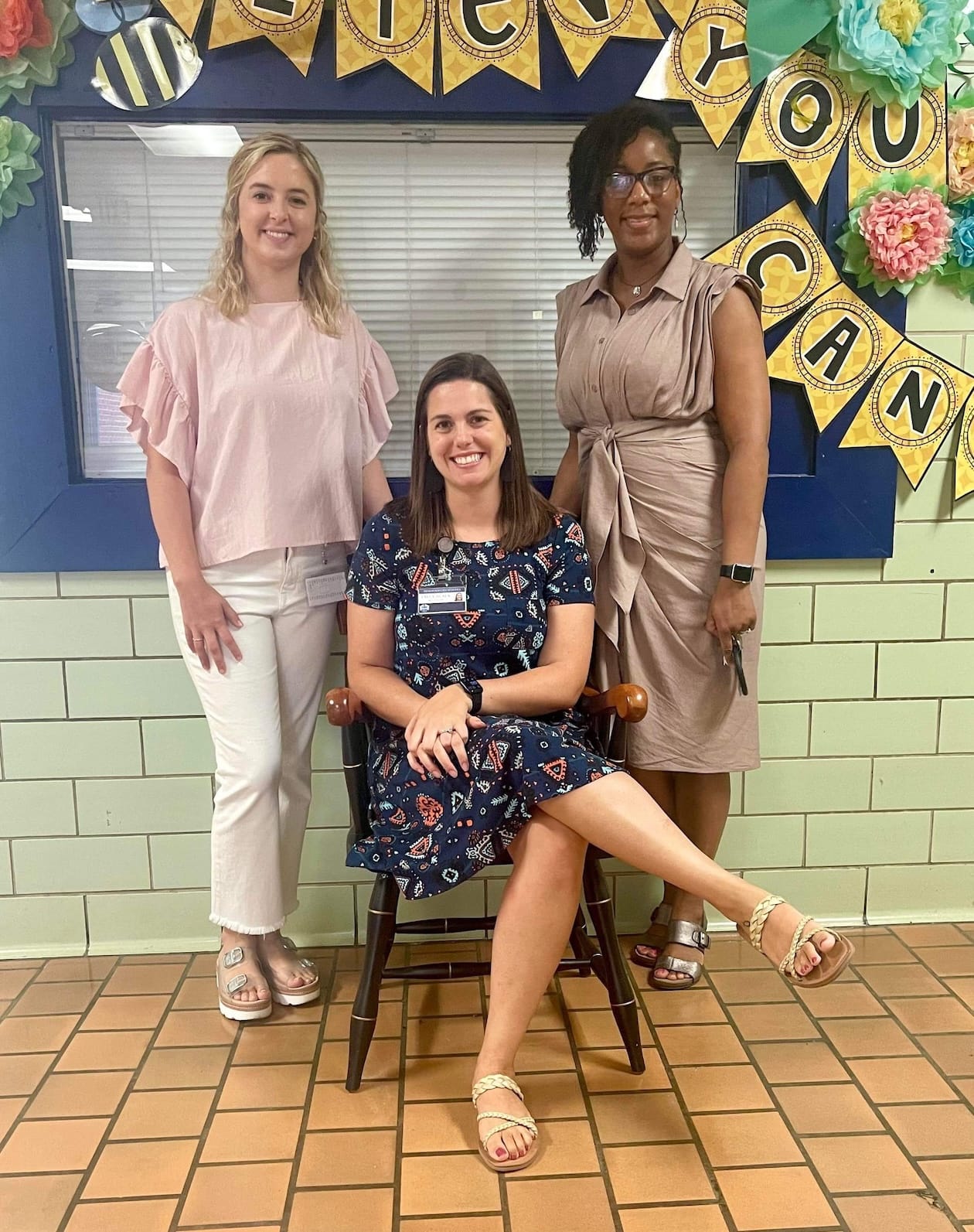 2022 SchoolFest coordinators at WES were Alyssa Stewart, left, and Emily Black, seated on the official DCSF chair. They are shown with WES principal Tisha Lewis.